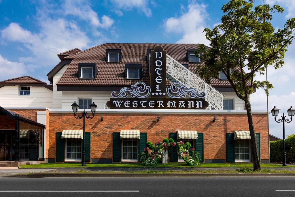 un bâtiment avec un panneau sur son côté dans l'établissement Hotel Westermann, à Oelde