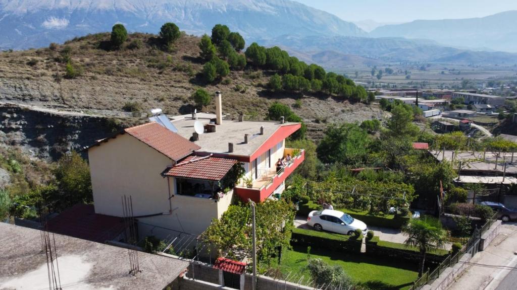 a house on top of a hill with a car at GuestHouseMantho in Gjirokastër