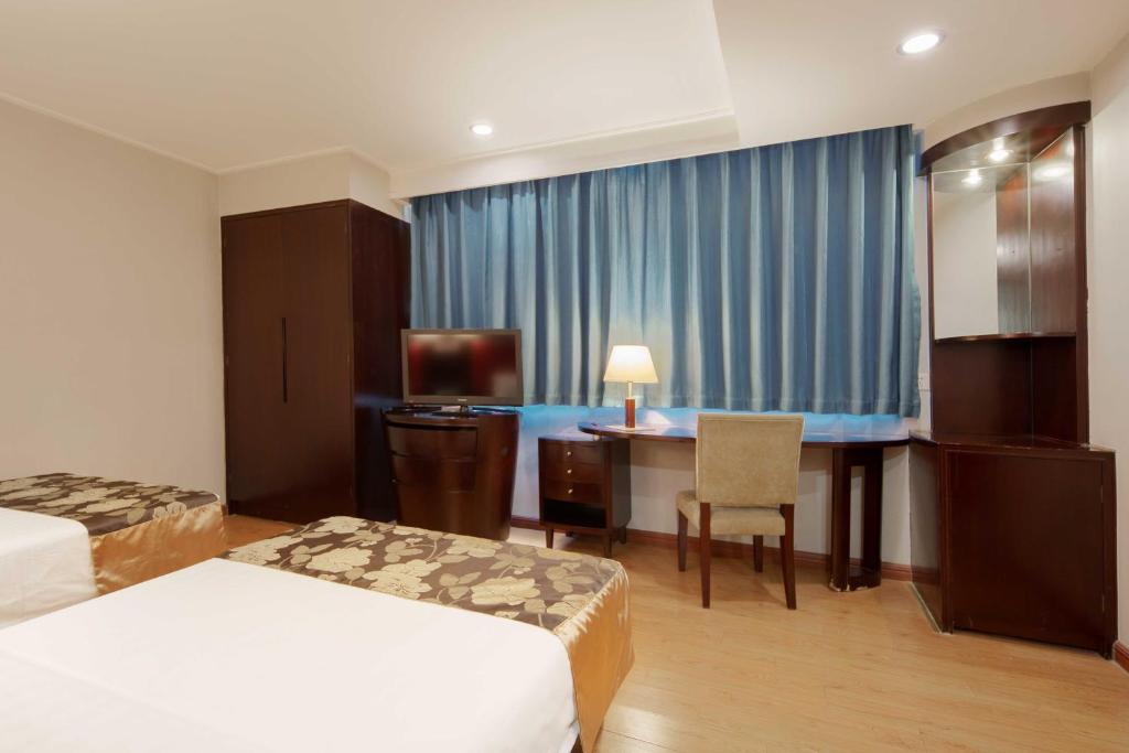 Postel nebo postele na pokoji v ubytování Foshan Guanxin Hotel