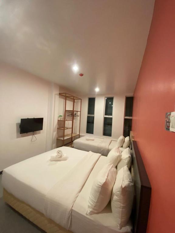 Postel nebo postele na pokoji v ubytování TT Dorf Hotel Taiping