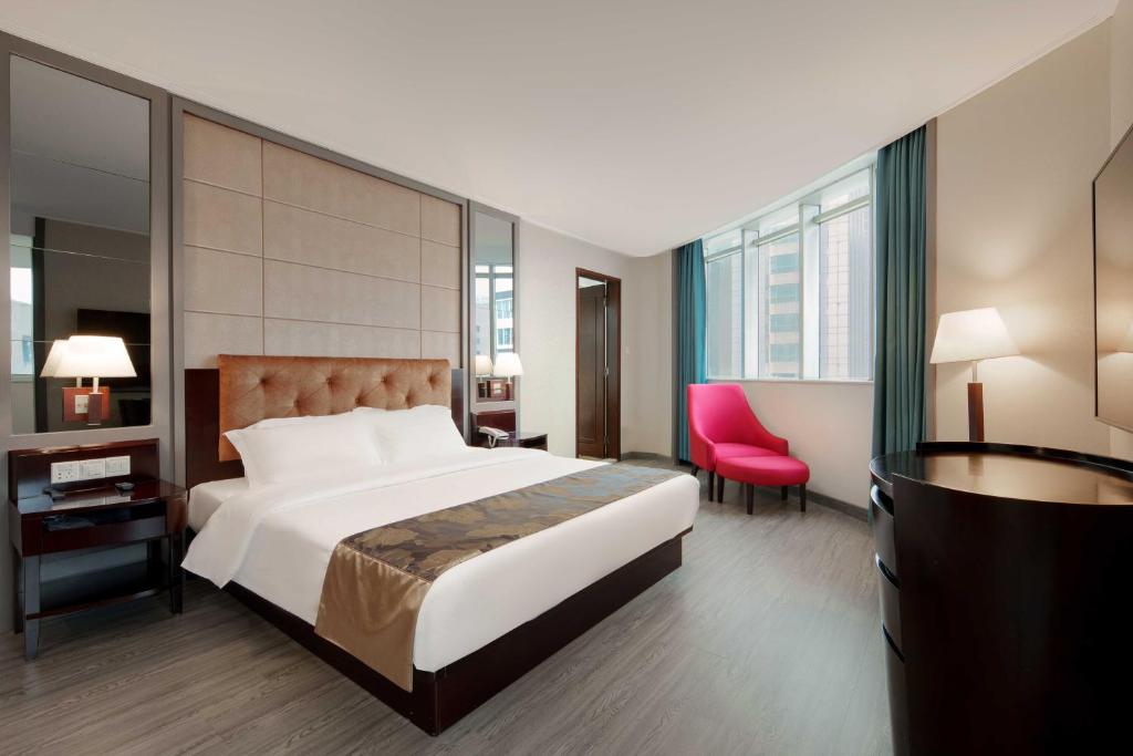 Postel nebo postele na pokoji v ubytování Foshan Guanxin Hotel