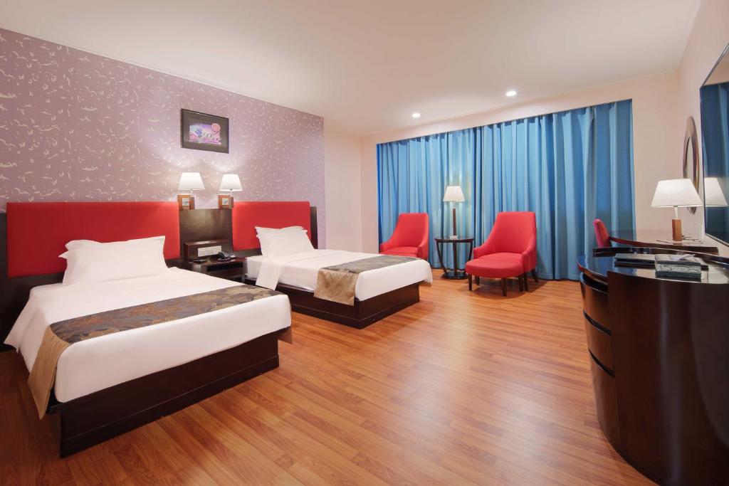 Postel nebo postele na pokoji v ubytování Foshan Guanxin Hotel