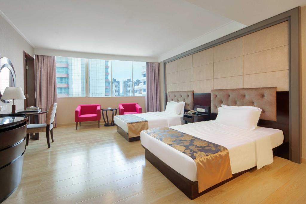 Postel nebo postele na pokoji v ubytování Foshan Guanxin Hotel