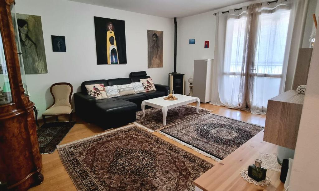 a living room with a couch and a table at Tuscan Gallery House in Grosseto