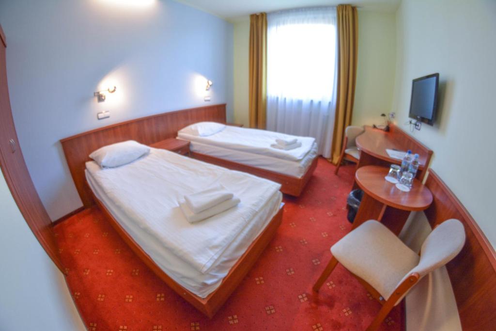 Postel nebo postele na pokoji v ubytování Hotel Neo