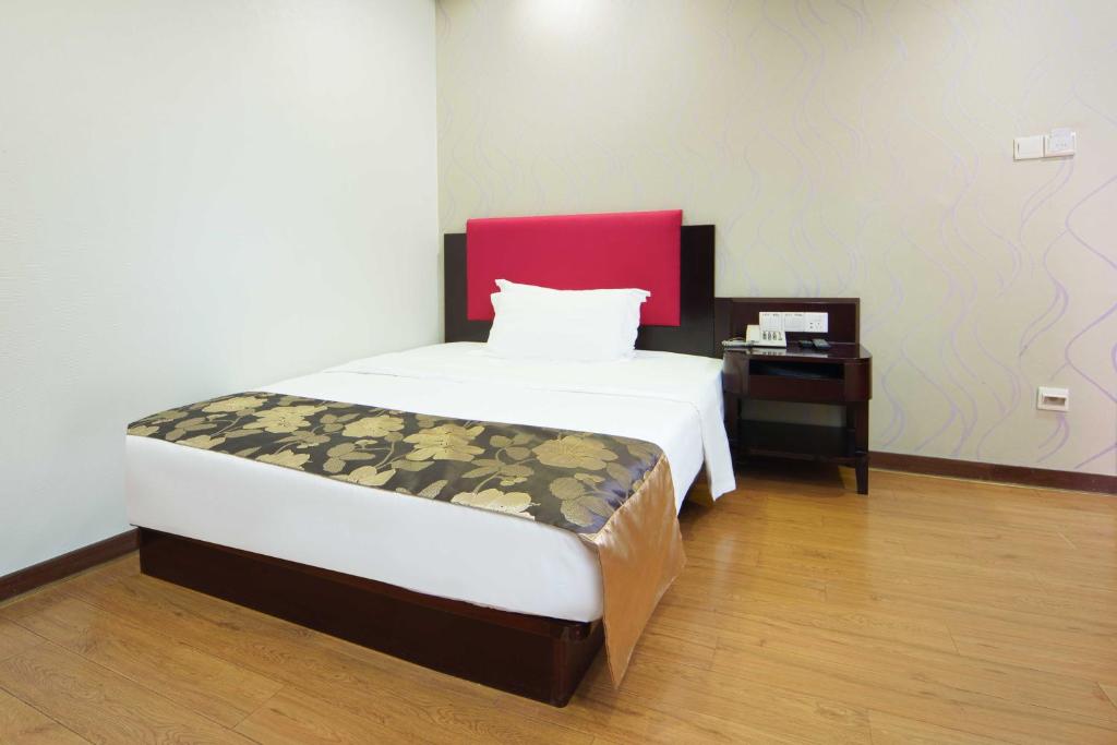 Postel nebo postele na pokoji v ubytování Foshan Guanxin Hotel