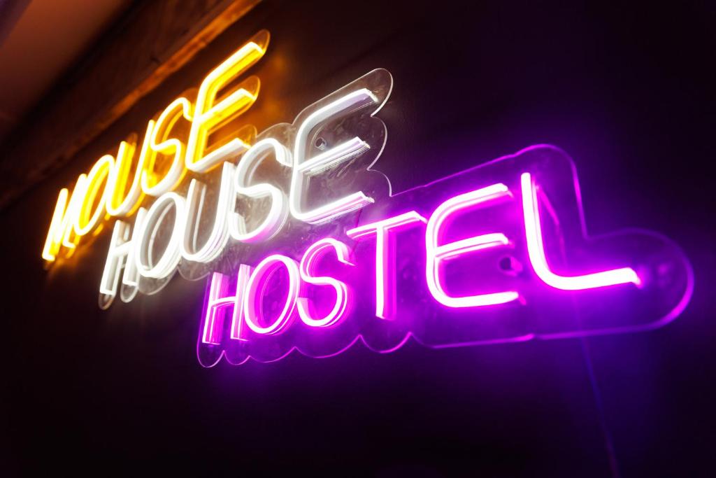 a neon sign for a hotel hocel sign at Mouse House Hostel in Almaty