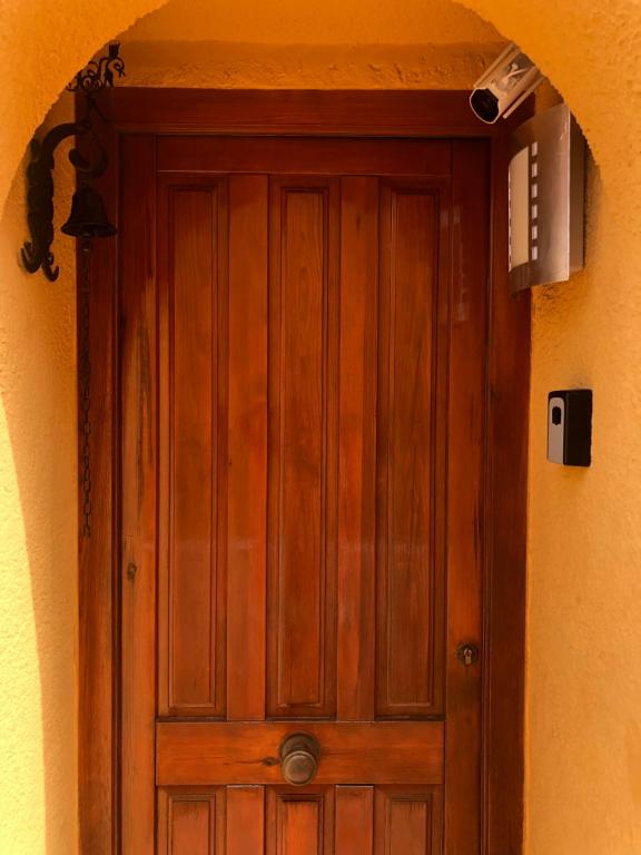 a wooden door in the middle of a building at Paraíso in Cumbre del Sol