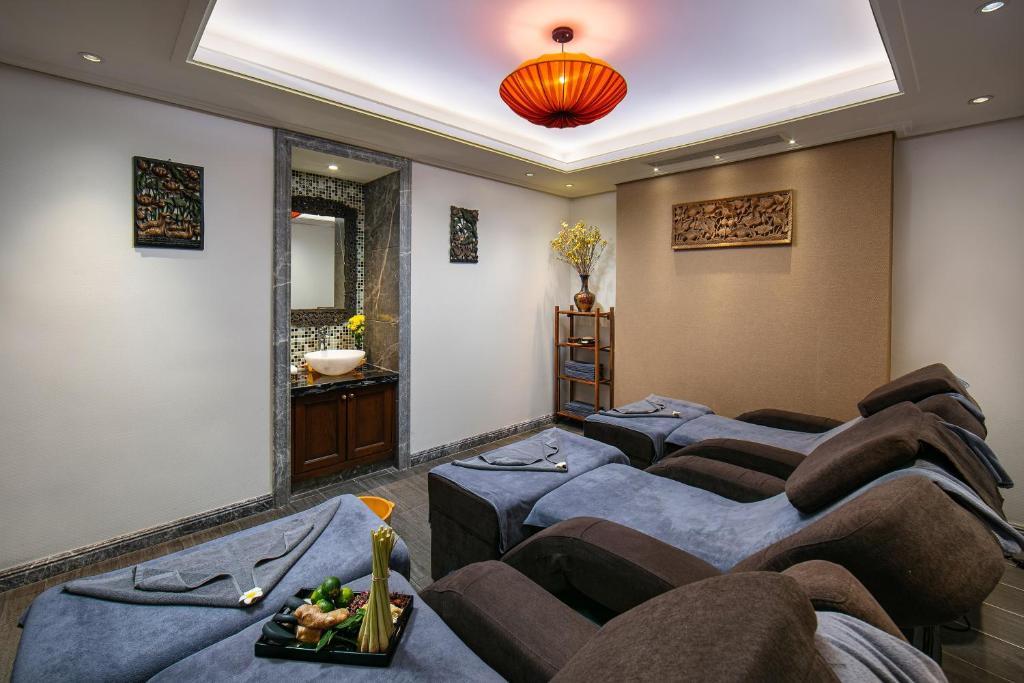 a room with a bunch of chairs in a room at Lucien Hanoi Lakeside Hotel & Rooftop in Hanoi