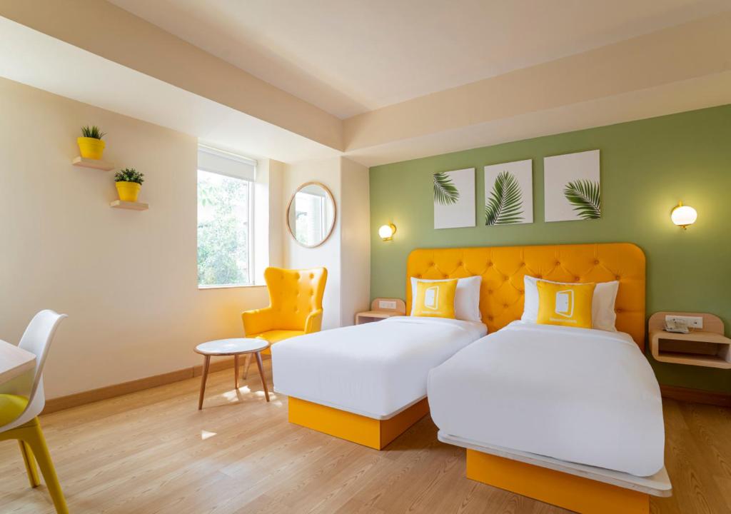 Postel nebo postele na pokoji v ubytování Bloom Hotel - Sector 19