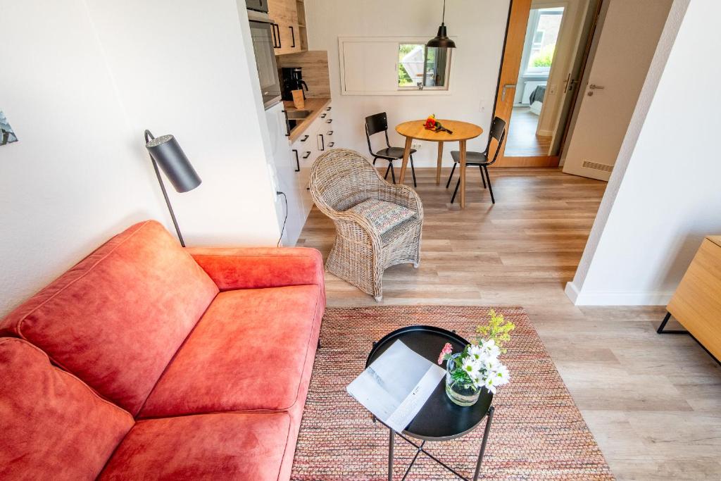a living room with a couch and a table at Steger-Hüs Wohnung 09 in Rantum