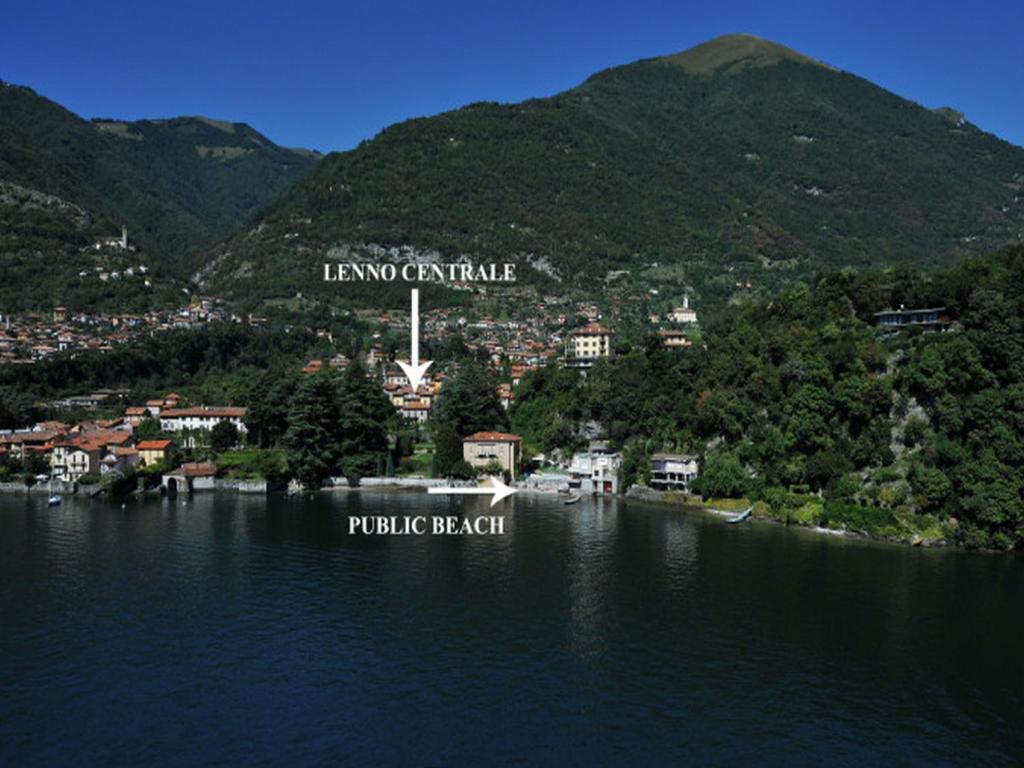 a small town on the shore of a body of water at Lenno Centrale in Lenno