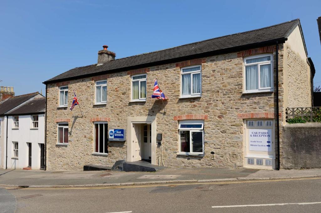 a brick building with two american flags on it at Best Western Fowey Valley in Lostwithiel