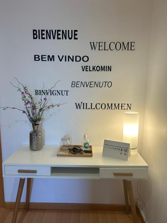 a white desk with words on the wall at Beach House Carmen 2 in Monte Gordo
