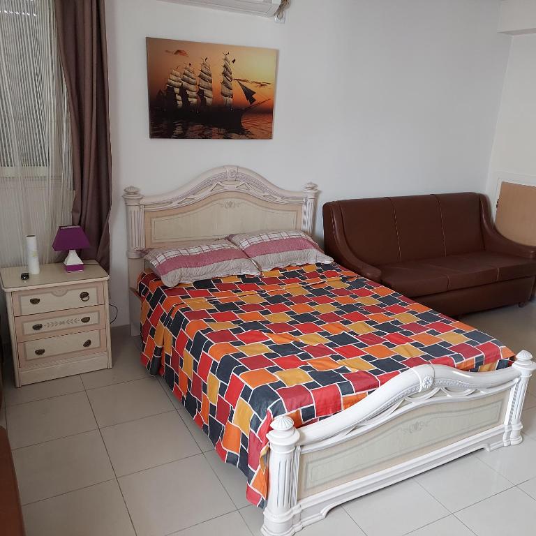 a bedroom with a bed and a couch at STATION KERDJOU TIARET in Tiaret