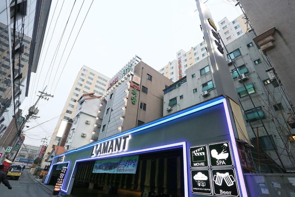 a bus on a city street with tall buildings at Motel Lamant in Bucheon