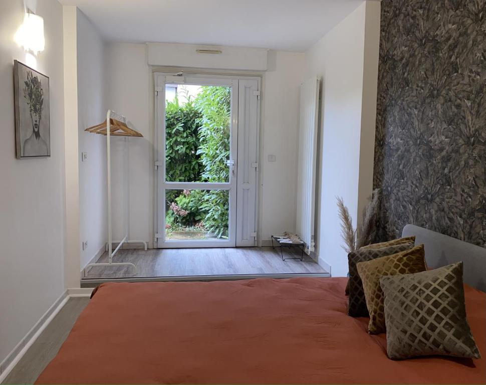 a living room with a large window and an orange rug at House Spa Privatif - Jaccuzi et Sauna in Livry-Gargan