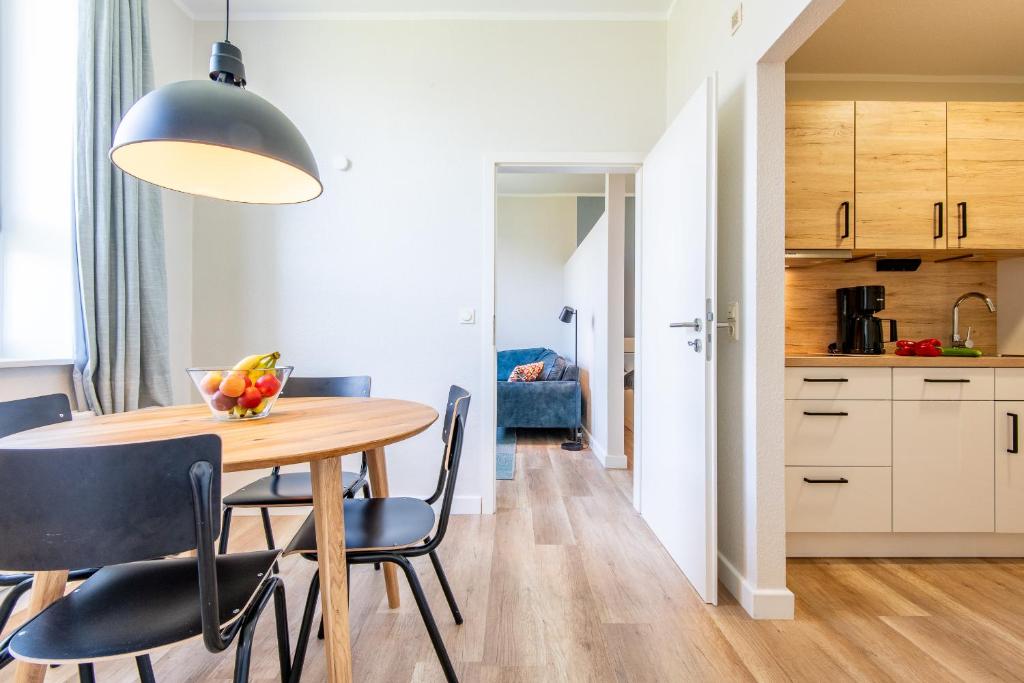 a kitchen and dining room with a table and chairs at Steger-Hüs Wohnung 16 in Rantum