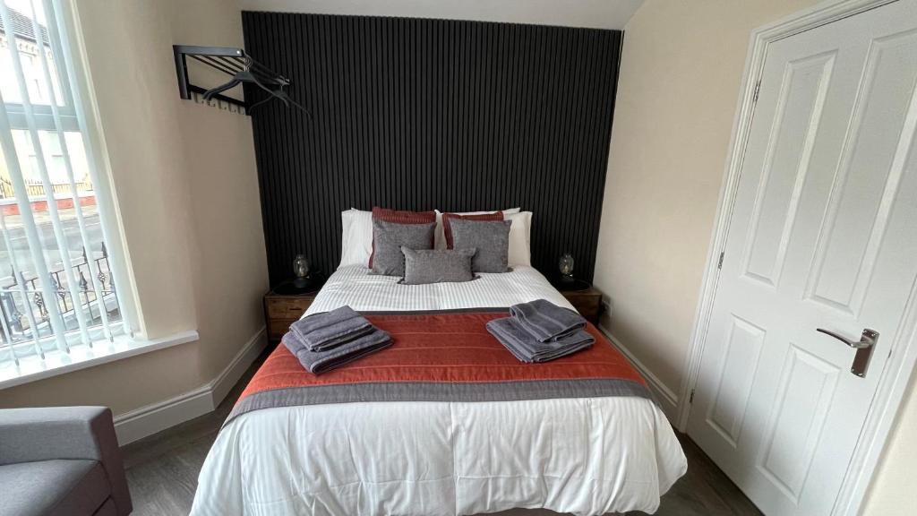 a bedroom with a bed with towels on it at ANFIELD PLACE TO STAY in Liverpool