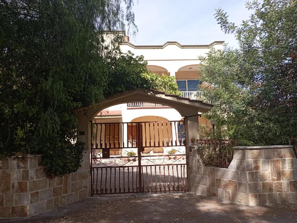 a gate in front of a house with a fence at Casa vacanze Il Carrubo in Leporano