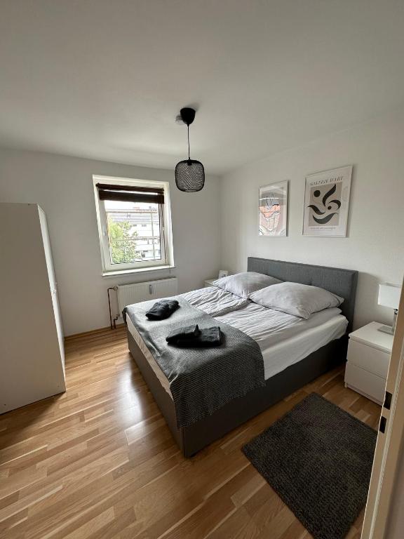 a bedroom with a large bed and a wooden floor at Schöne Wohnung im Herzen von Köln Ehrenfeld in Cologne