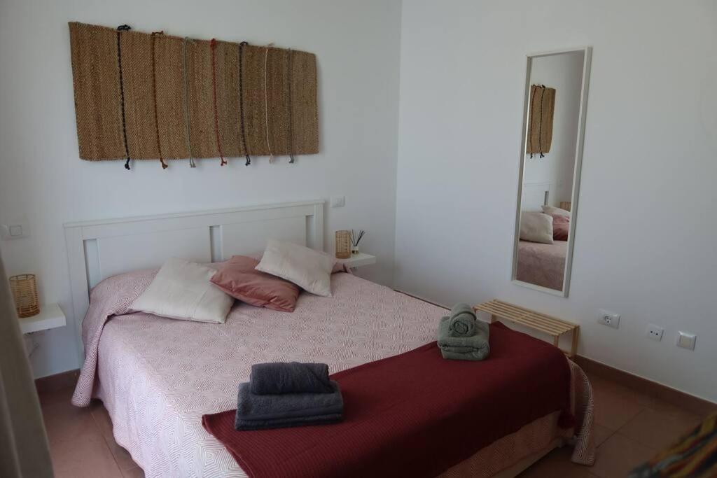 a bedroom with a bed with two towels on it at Brisas de Puerto Rico in Puerto Rico de Gran Canaria
