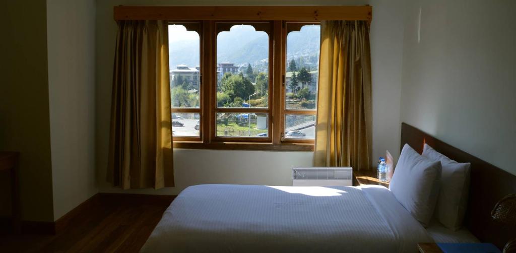 Postel nebo postele na pokoji v ubytování Hotel Amodhara