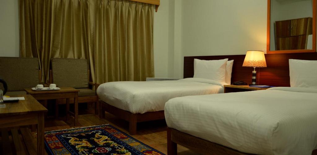 Postel nebo postele na pokoji v ubytování Hotel Amodhara