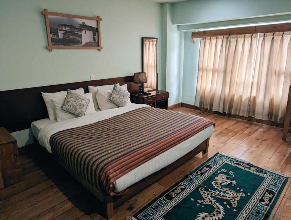 Postel nebo postele na pokoji v ubytování Hotel Amodhara