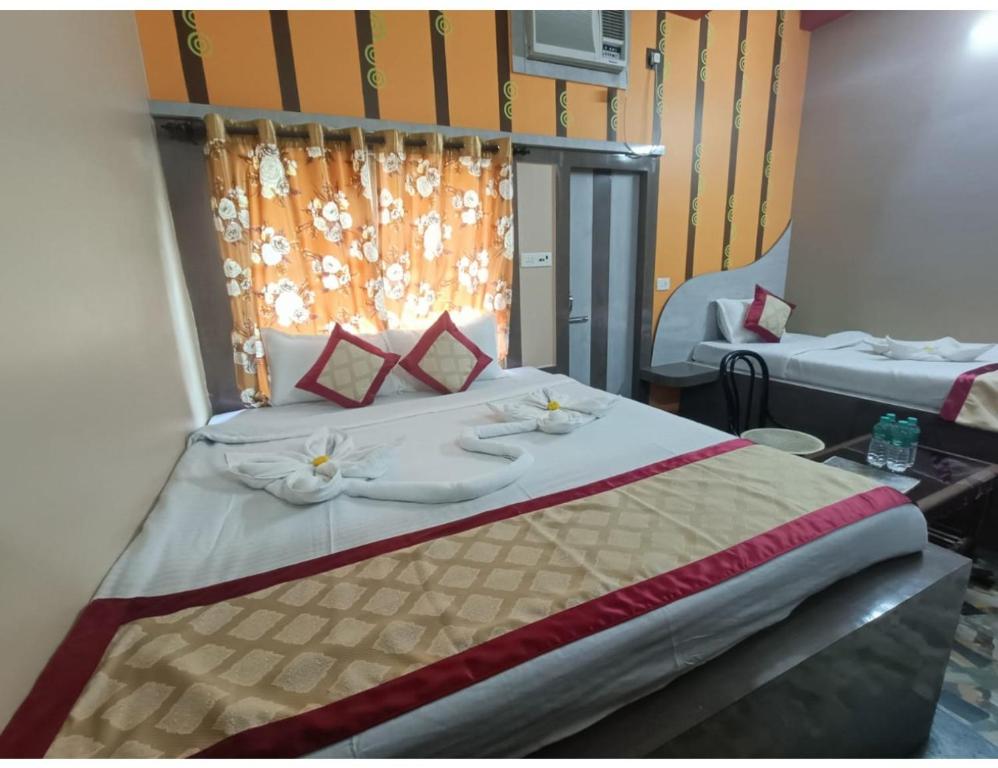 een slaapkamer met een bed met bloemen erop bij EMBLIC HOTEL & RESTAURANT, Bolpur in Bolpur