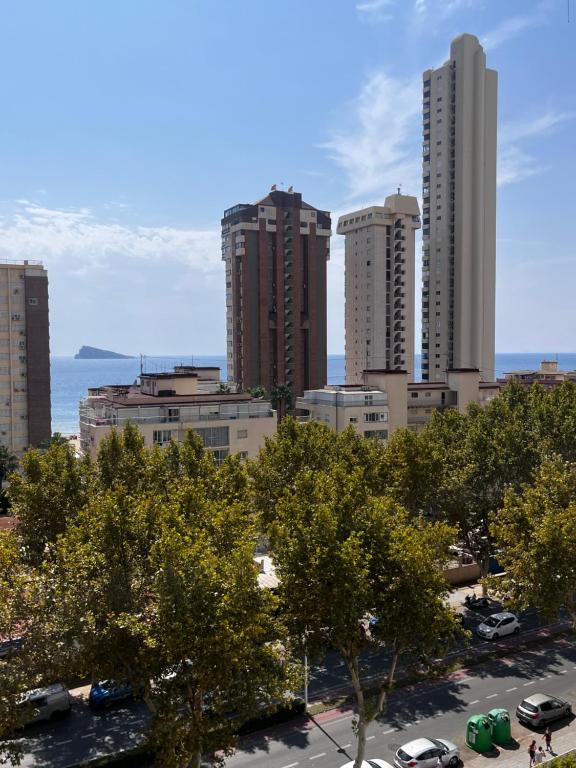 a city with tall buildings and cars in a parking lot at ANNA SUN holiday apt in Benidorm