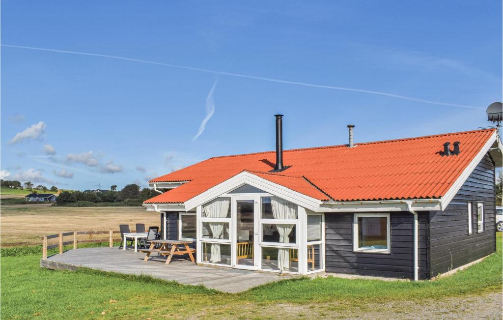 a small house with an orange roof and a deck at Awesome Home In Ebeltoft With Private Swimming Pool, Can Be Inside Or Outside in Ebeltoft