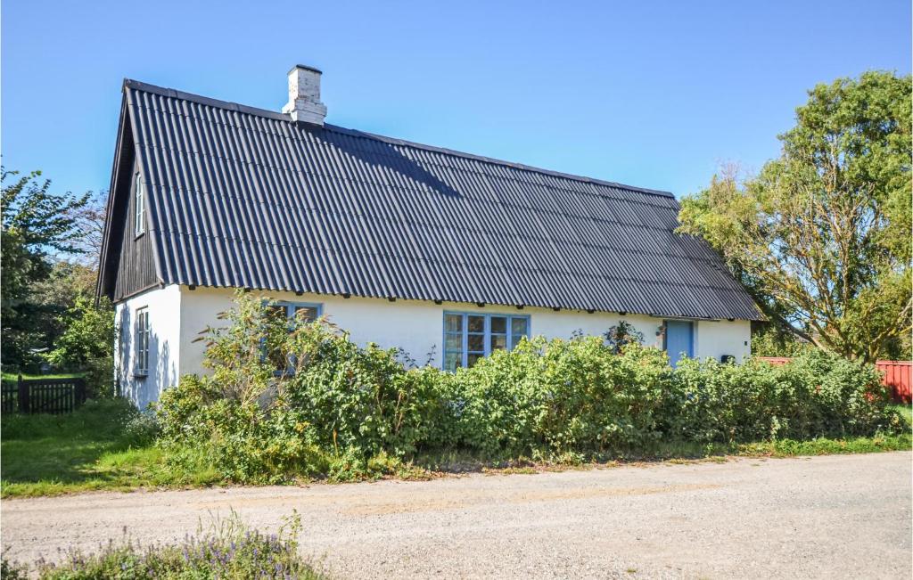 a white house with a black roof at Beautiful Home In Anholt With Kitchen in Anholt