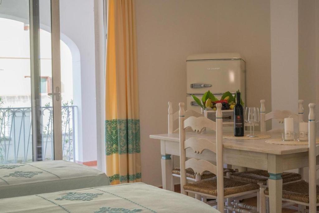 a dining room with a table and a table and a window at Superb Le Residenze del Golfo di Orosei num2192 in Orosei