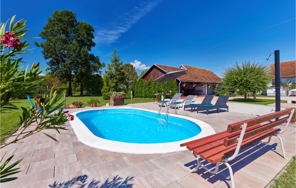 a swimming pool with a bench and a table at Pet Friendly Home In Gudovac With Wifi in Gudovac