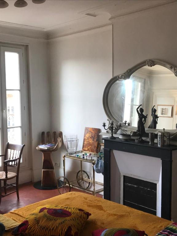 uma sala de estar com lareira e espelho em 19 em Marselha