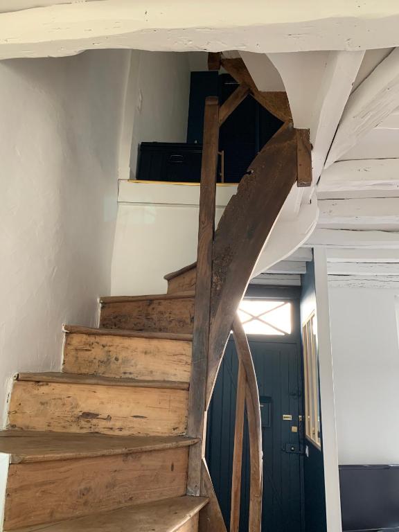 a wooden staircase in a room with a ceiling at Maison Angouleme, France in Angoulême