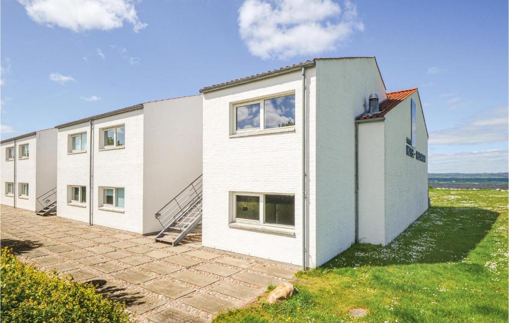 a white building with windows on the side of it at Amazing Apartment In Ebeltoft With House Sea View in Ebeltoft
