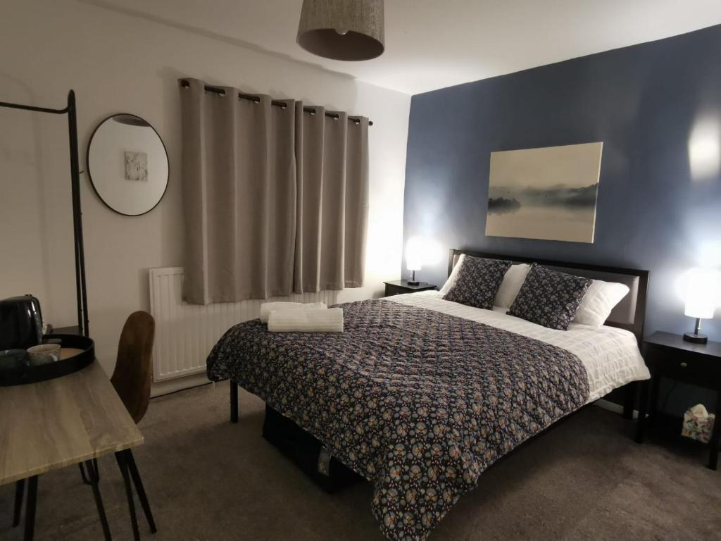 sypialnia z łóżkiem i niebieską ścianą w obiekcie 2 x King & 1 Single bedroom - Sleeps 5 - Kitchen - by Canal w mieście Barton under Needwood