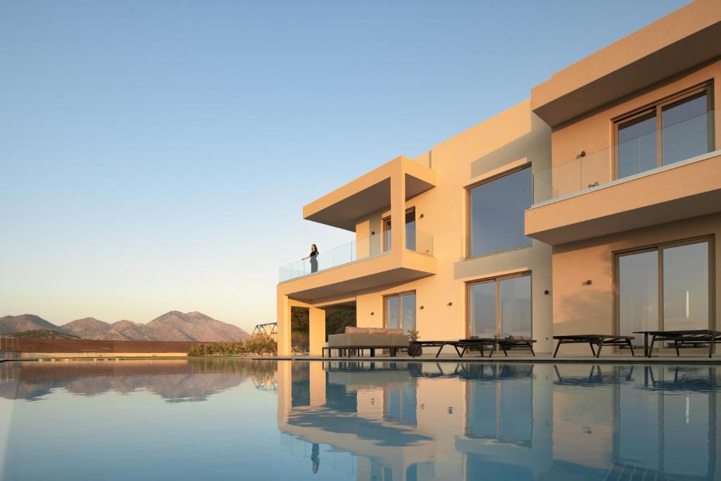 a house with a pool in front of it at Casa Beleza Villa, a Mythical Retreat, By ThinkVilla in Perama