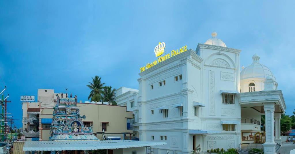 a white building with a sign on top of it at The Grand White Palace in Sīrkāzhi