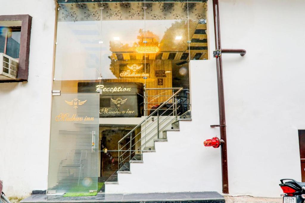 a store front with a staircase in a window at Hotel Madhav Inn Top Family Hotels Business Hotels Best Couple Friendly Hotel in Lucknow in Lucknow