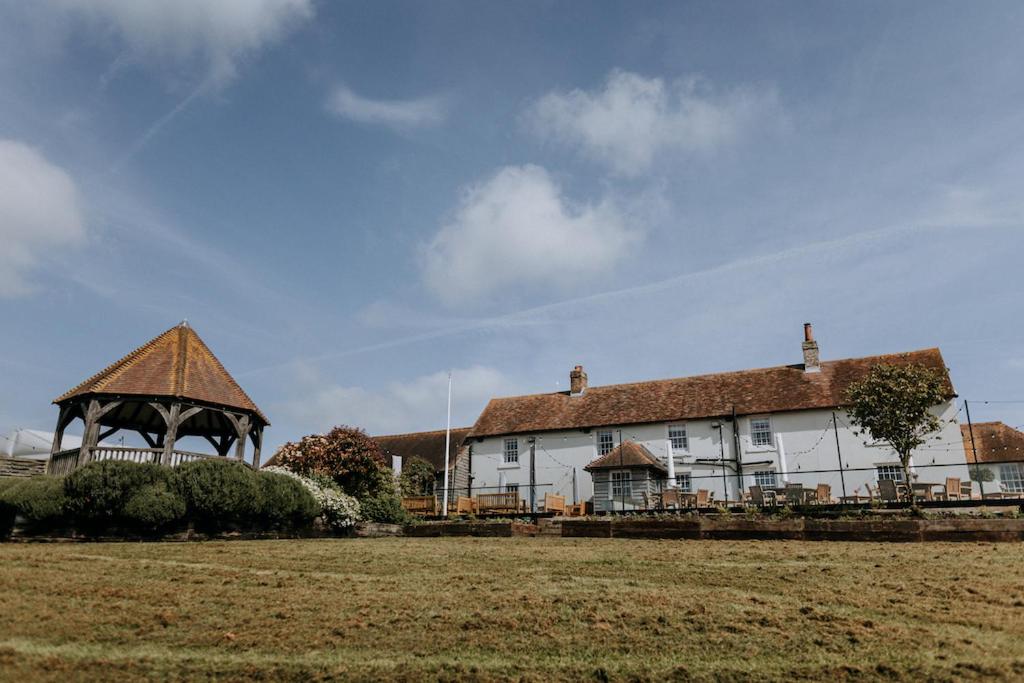 a large white house with a gazebo in front of it at The Ferry House in Eastchurch