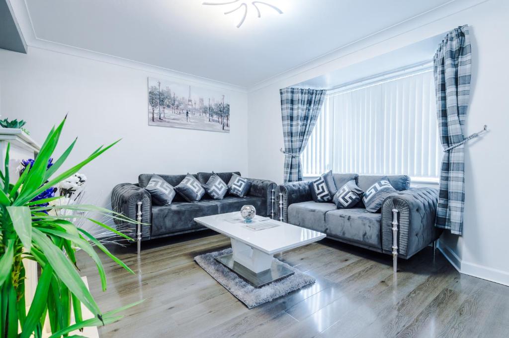 a living room with a couch and a table at Home Away Apartment in Manchester