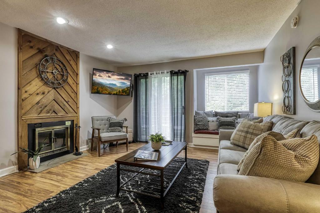 a living room with a couch and a fireplace at Cozy Resort-Style Condo Less Than 2 Mi to Ober Gatlinburg! in Gatlinburg
