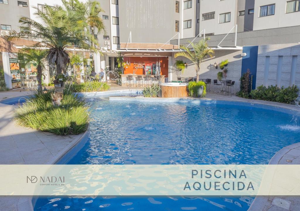 a swimming pool in the middle of a building at Nadai Confort Hotel e Spa in Foz do Iguaçu