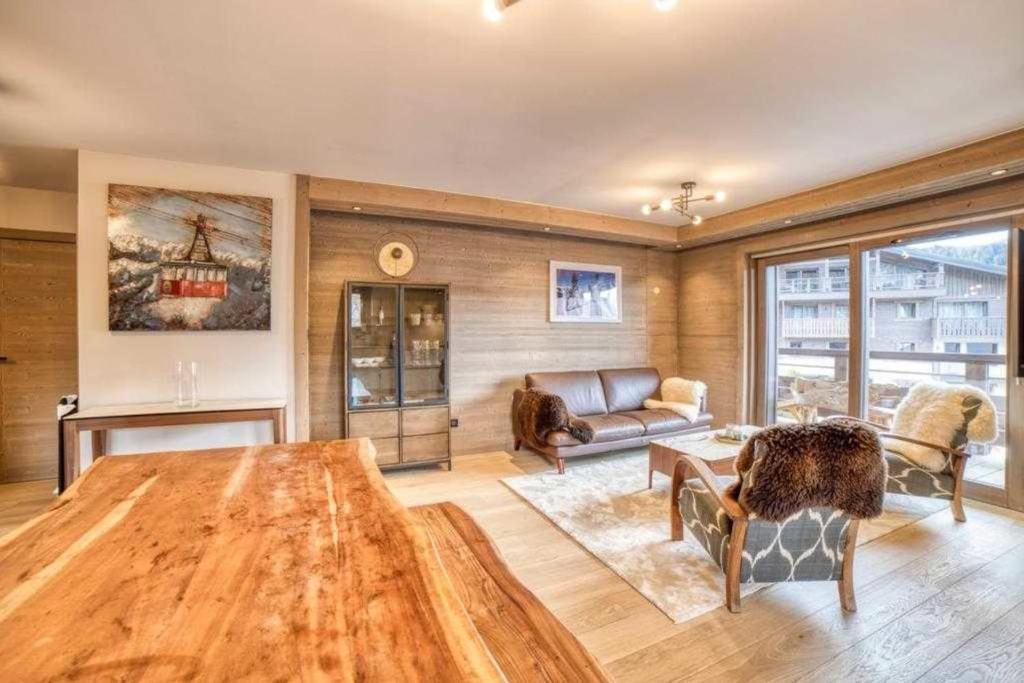 ein Wohnzimmer mit einem Sofa und einem Tisch in der Unterkunft High standing 6P3BR apartment - Résidence Stallion Megève in Megève