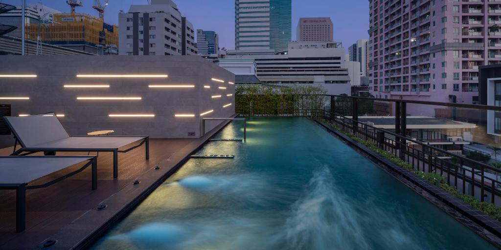 a swimming pool on the roof of a building at PASSA Hotel Bangkok in Bangkok