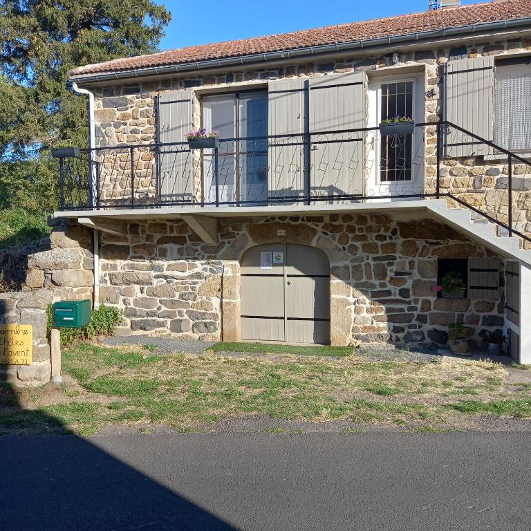 a stone house with a balcony and a garage at Boufavent in Salettes