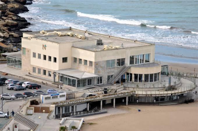 a building on the beach next to the ocean at Playa grande in Mar del Plata